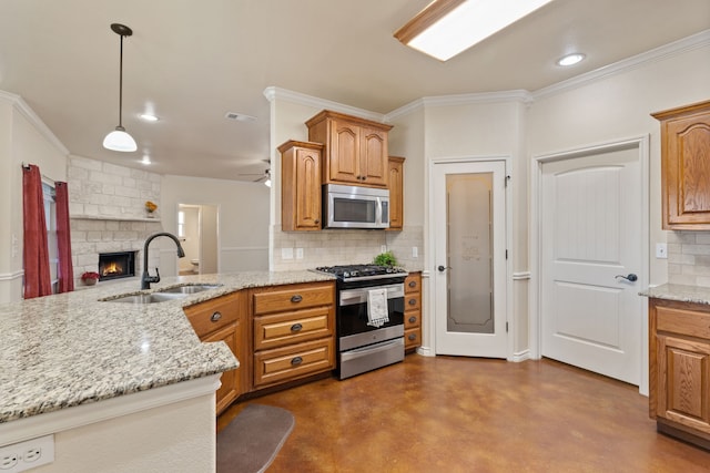 kitchen with pendant lighting, appliances with stainless steel finishes, sink, backsplash, and ceiling fan