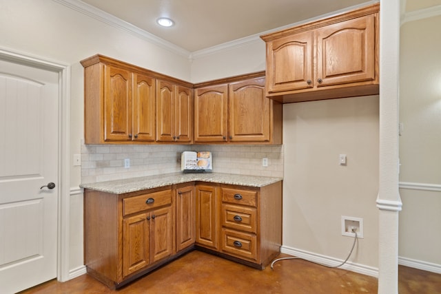 kitchen featuring concrete floors, crown molding, tasteful backsplash, and light stone counters