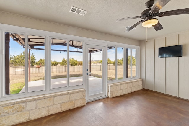 doorway to outside featuring ceiling fan and a textured ceiling