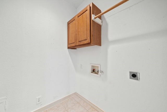 clothes washing area featuring washer hookup, cabinets, light tile patterned floors, and hookup for an electric dryer