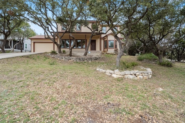 view of front of home with a garage and a front yard