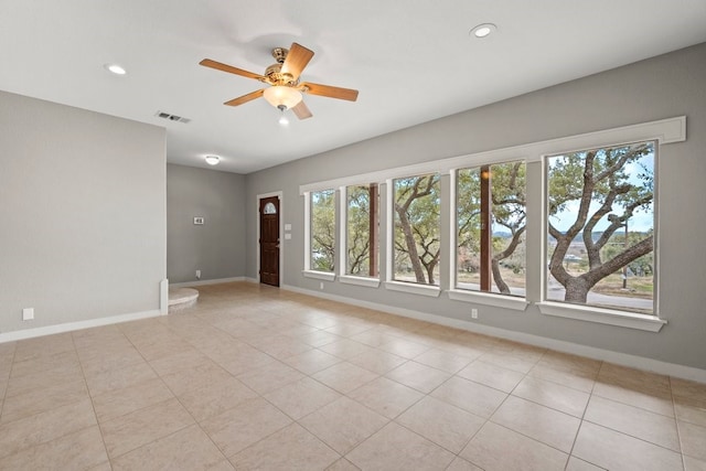 spare room featuring light tile patterned flooring and ceiling fan