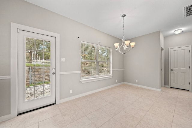 unfurnished dining area featuring light tile patterned floors and an inviting chandelier