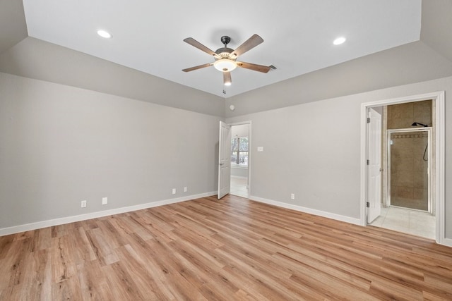 empty room featuring light hardwood / wood-style floors, lofted ceiling, and ceiling fan