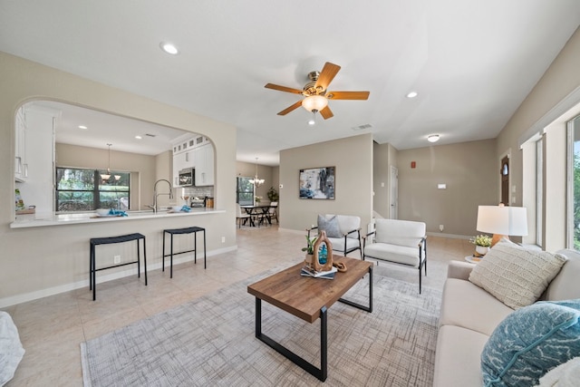 1735 Lake Blf, Canyon Lake, TX 78133 - living area featuring arched walkways, ceiling fan, light tile patterned floors, and recessed lighting