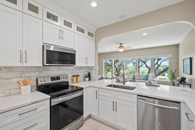 1735 Lake Blf, Canyon Lake, TX 78133 - kitchen with stainless steel appliances, decorative backsplash, recessed lighting, a ceiling fan, and white cabinetry
