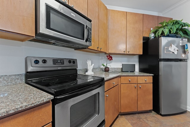 kitchen featuring appliances with stainless steel finishes and light stone counters