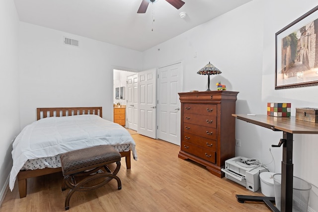 bedroom featuring light hardwood / wood-style floors and ensuite bathroom