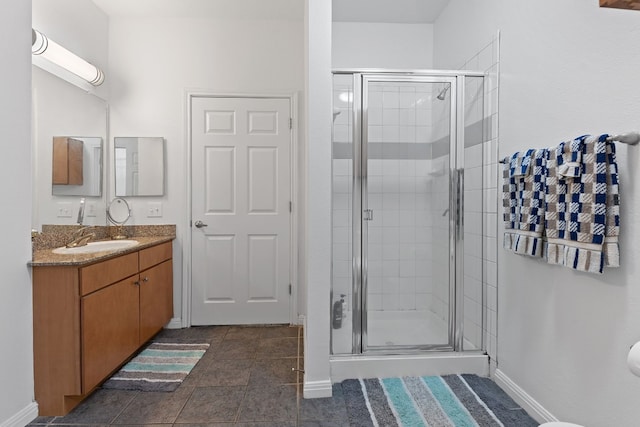 bathroom featuring an enclosed shower, vanity, and tile patterned flooring