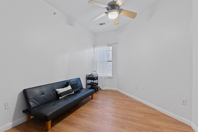 living area with ceiling fan and light wood-type flooring