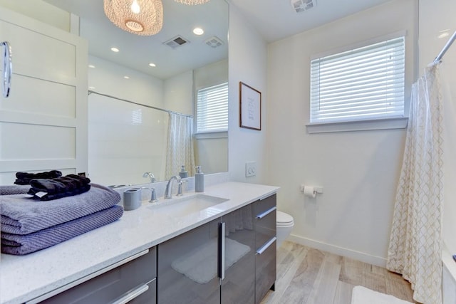 bathroom featuring toilet, a shower with shower curtain, wood-type flooring, and vanity