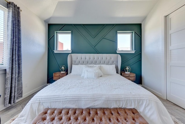 bedroom featuring light hardwood / wood-style flooring and multiple windows