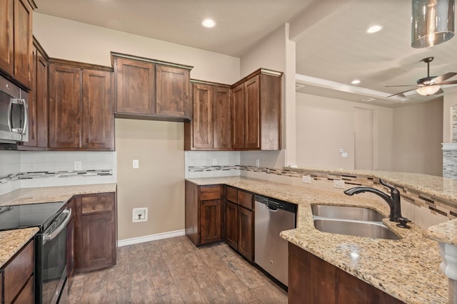 kitchen featuring ceiling fan, light stone countertops, and appliances with stainless steel finishes