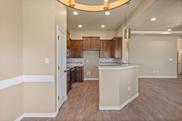 kitchen with hardwood / wood-style floors, appliances with stainless steel finishes, light stone counters, and tasteful backsplash