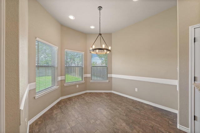 unfurnished dining area with a chandelier