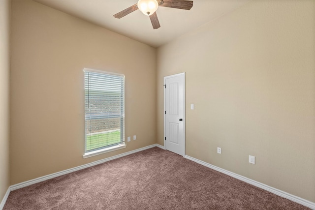 carpeted spare room with ceiling fan and lofted ceiling