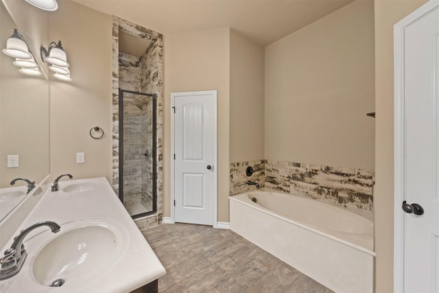 bathroom with vanity and shower with separate bathtub