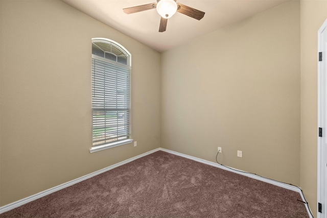 spare room with ceiling fan and carpet