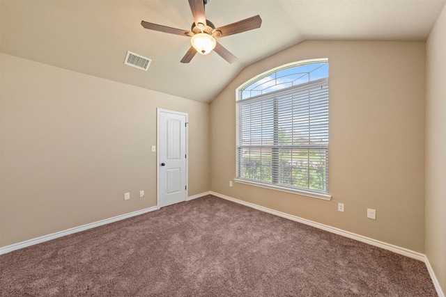 carpeted empty room with lofted ceiling, ceiling fan, and a wealth of natural light