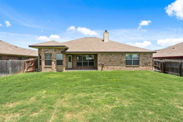 rear view of house featuring a patio and a yard