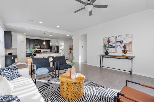 tiled living room with ceiling fan and vaulted ceiling