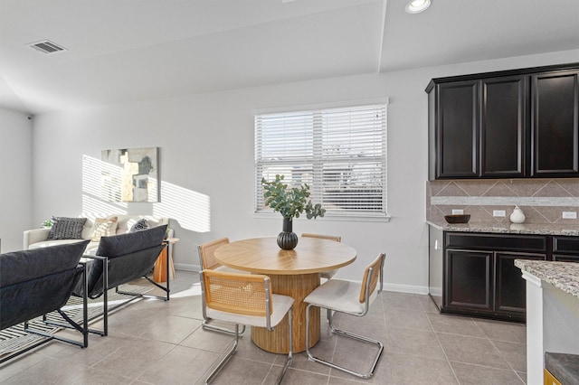 dining area featuring light tile patterned flooring