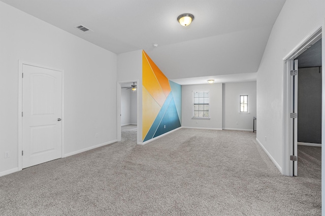 bonus room featuring ceiling fan and carpet