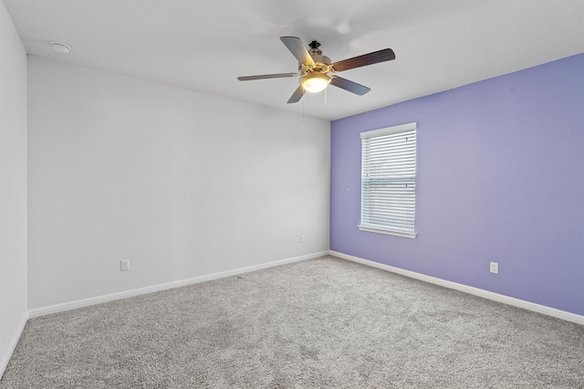 carpeted empty room featuring ceiling fan