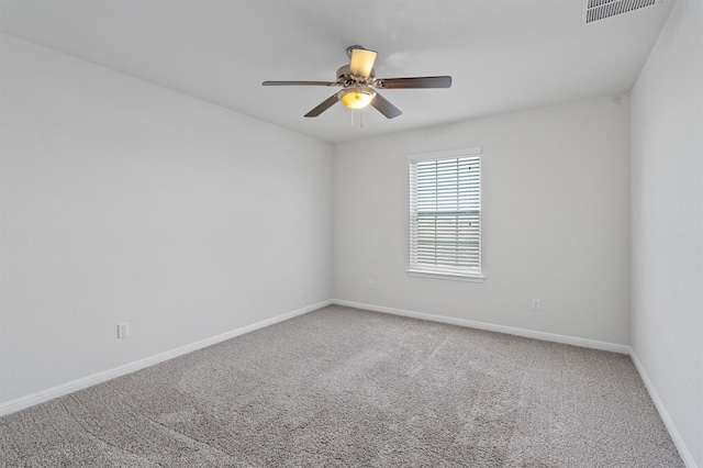 empty room with ceiling fan and carpet flooring