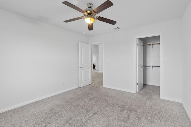 unfurnished bedroom featuring ceiling fan, light carpet, and a closet