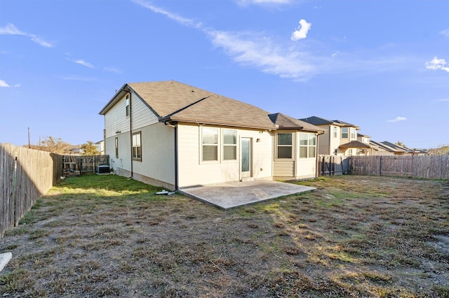 back of house featuring central air condition unit, a yard, and a patio