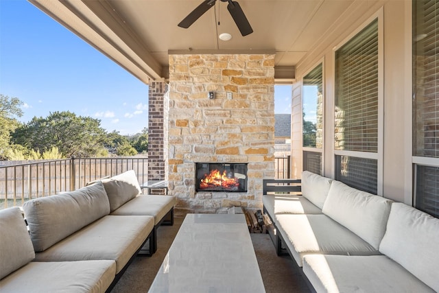 view of patio featuring ceiling fan, an outdoor living space with a fireplace, and fence