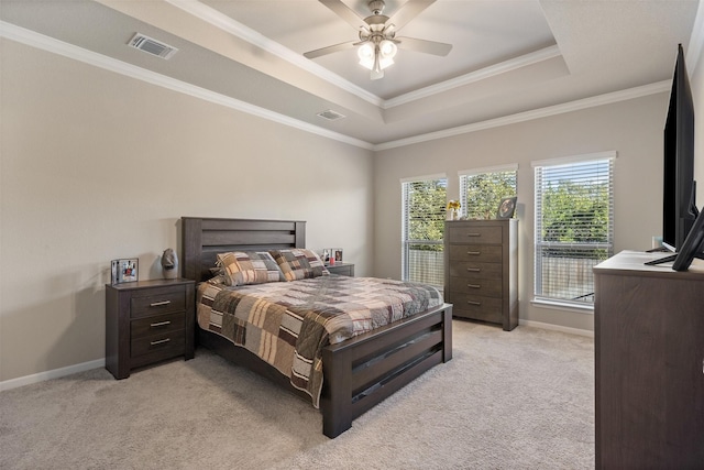 bedroom with light carpet, a raised ceiling, visible vents, and baseboards