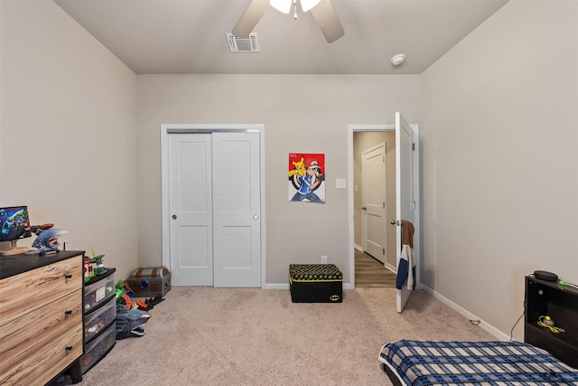 carpeted bedroom with baseboards, visible vents, ceiling fan, and a closet