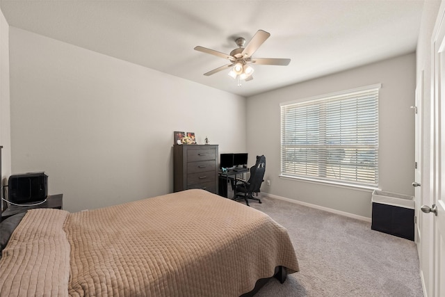 bedroom with ceiling fan, baseboards, and carpet flooring