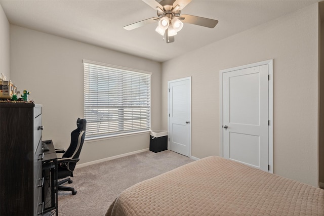 bedroom with a ceiling fan, baseboards, and carpet flooring