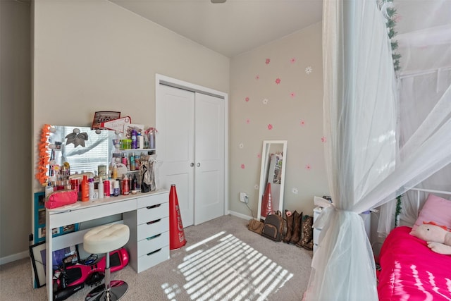 carpeted bedroom with baseboards and a closet