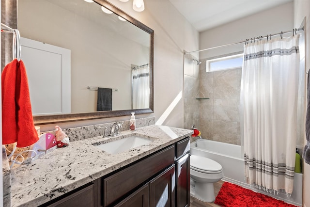 bathroom featuring toilet, vanity, and shower / tub combo with curtain