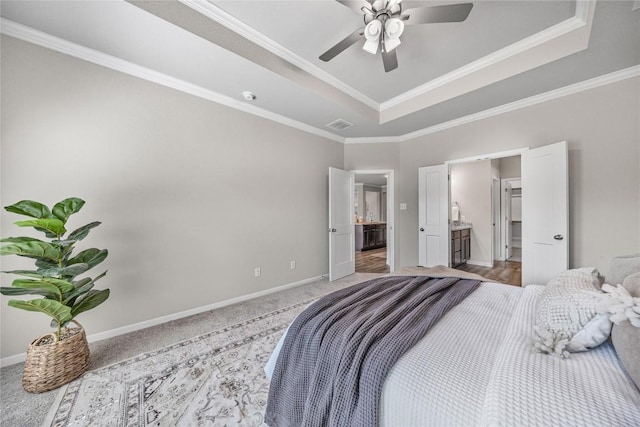 1207 Haley Ln, Salado, TX 76571 - bedroom with a raised ceiling, ornamental molding, light colored carpet, a ceiling fan, and ensuite bath