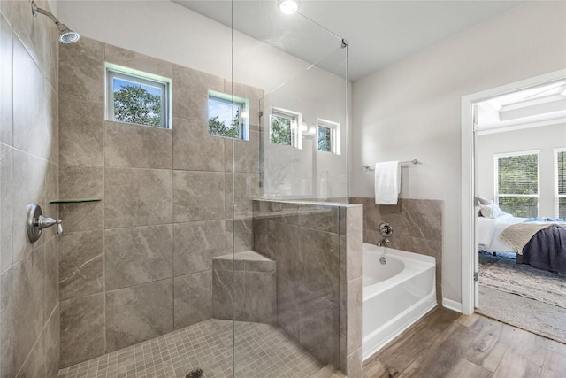 1207 Haley Ln, Salado, TX 76571 - bathroom featuring wood finished floors, a garden tub, ensuite bath, and a shower stall