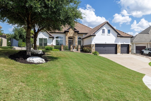 view of front of home with a front yard and a garage