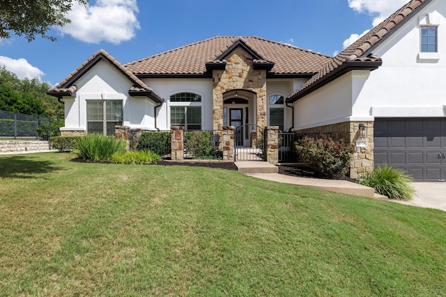 mediterranean / spanish house featuring a front lawn and a garage