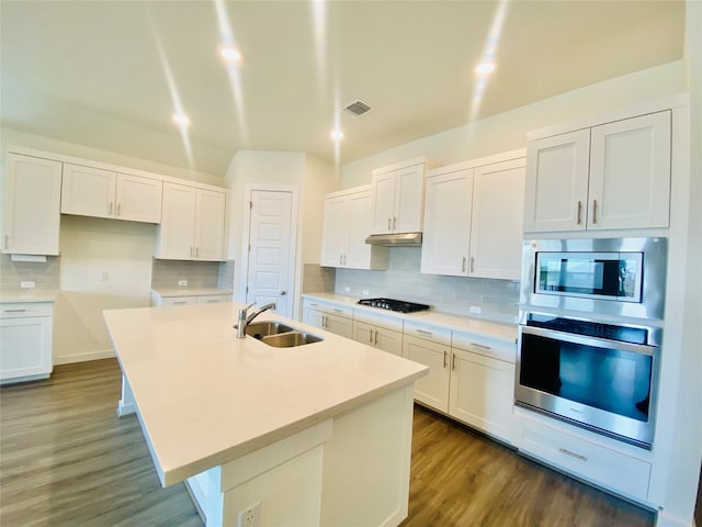 kitchen with white cabinetry, a center island with sink, stainless steel appliances, dark hardwood / wood-style floors, and sink