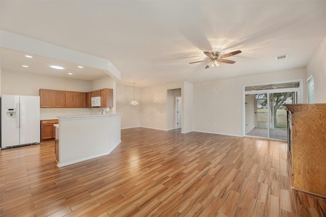 interior space with ceiling fan and light hardwood / wood-style floors