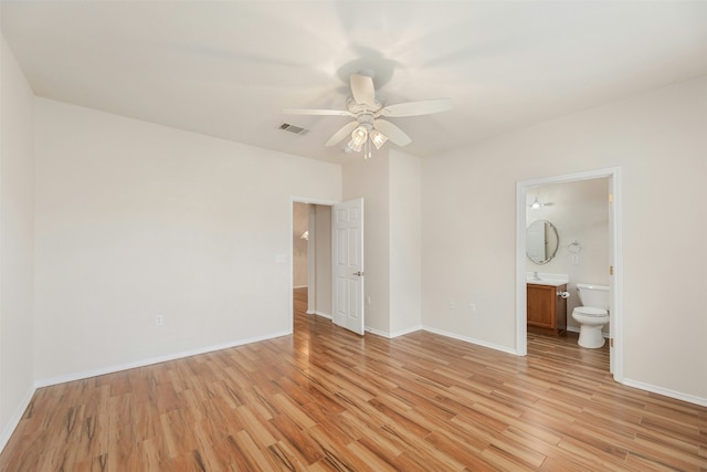 unfurnished bedroom with ensuite bath, ceiling fan, and light hardwood / wood-style floors