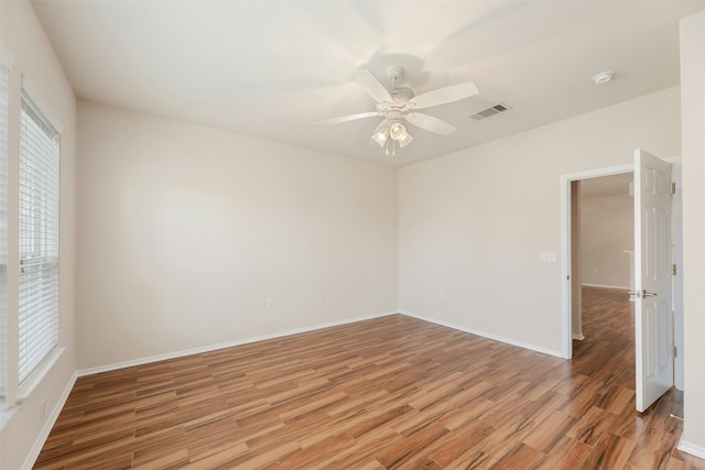 spare room featuring ceiling fan and light hardwood / wood-style flooring