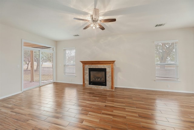 104 Honey Creek Trl, Georgetown, TX 78633 - unfurnished living room featuring ceiling fan, light wood-style flooring, a fireplace, and baseboards