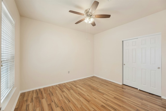 unfurnished room featuring ceiling fan, plenty of natural light, and light wood-type flooring