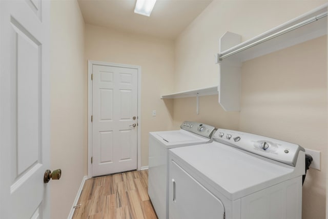 laundry room with light hardwood / wood-style floors and independent washer and dryer