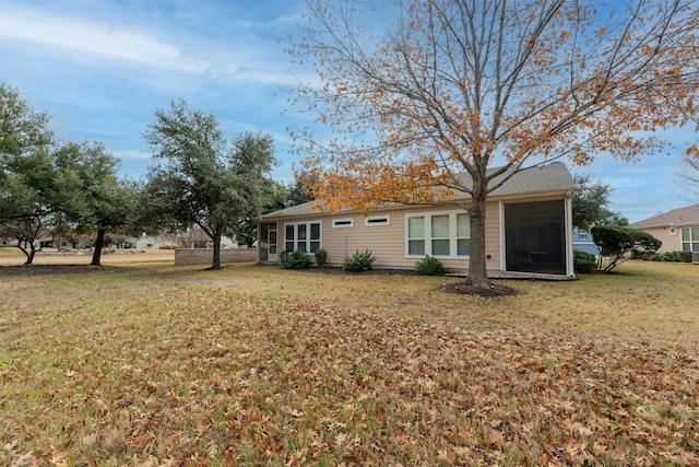 back of house featuring a lawn